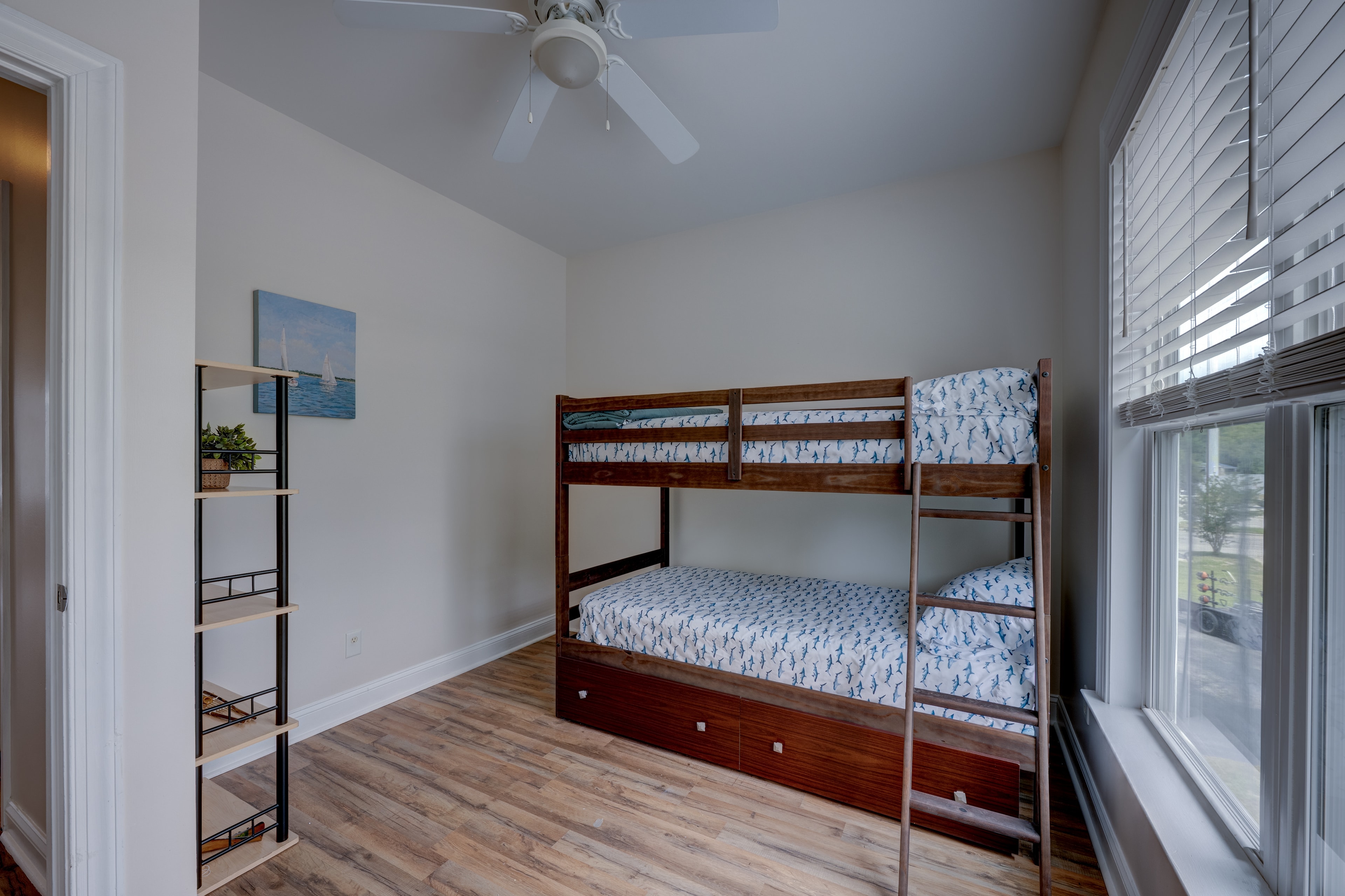 Second bedroom with hardwood floors and natural light