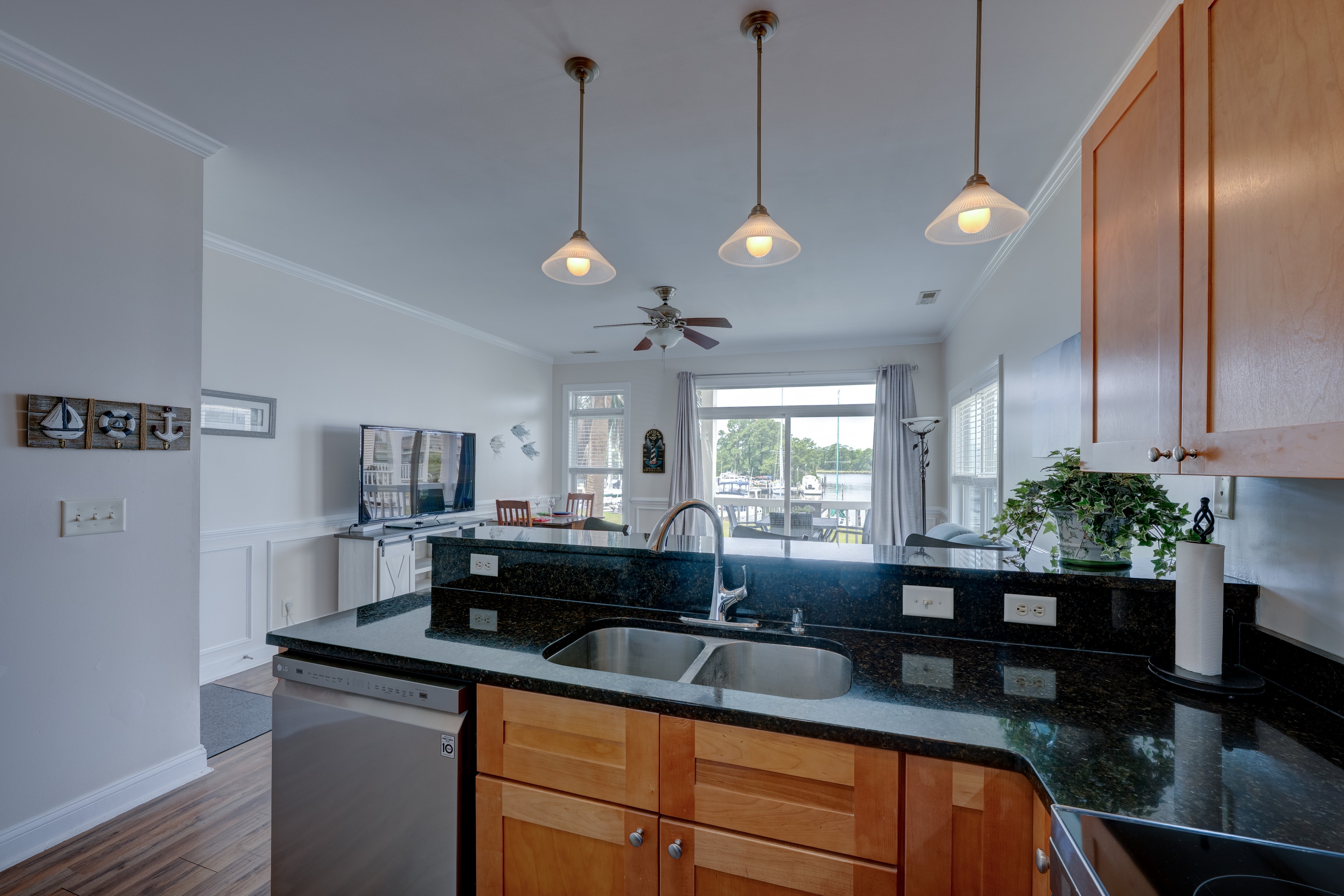 Updated kitchen with granite countertops and marina view through the window