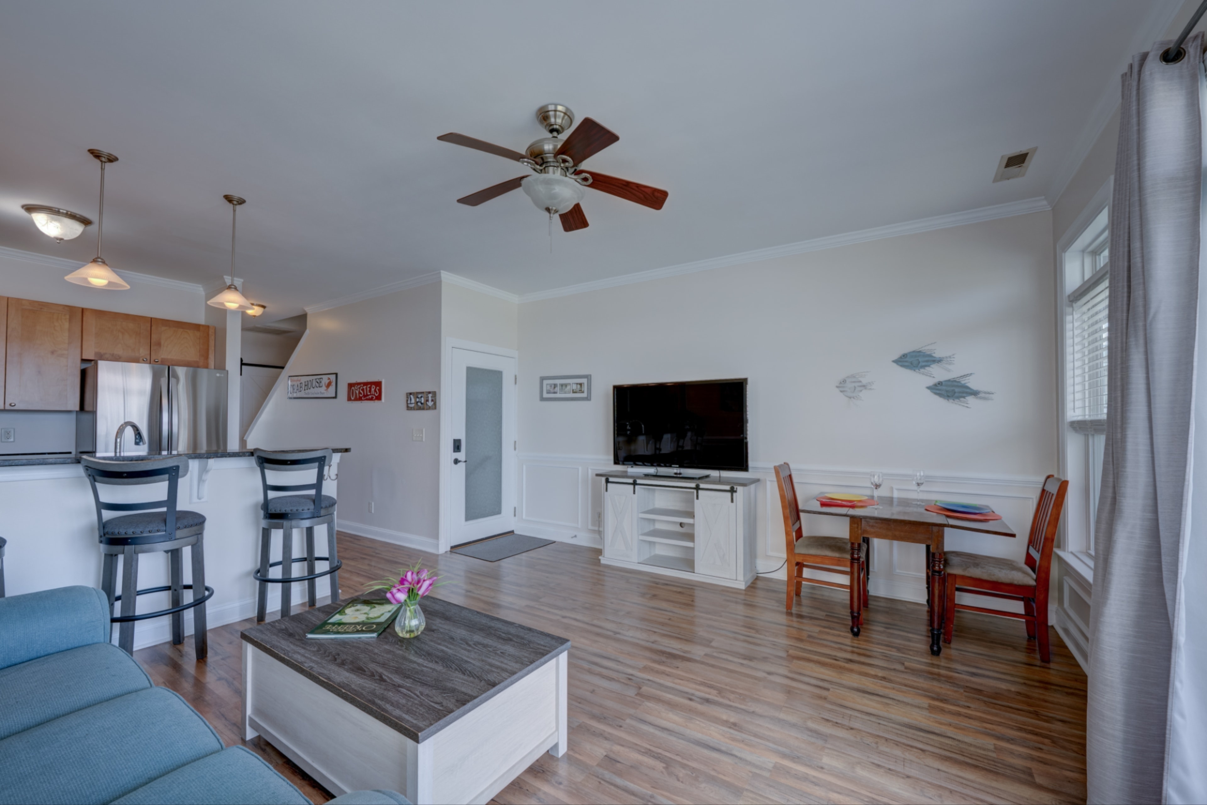 Kitchen, dining and living area with breakfast bar and coastal decor