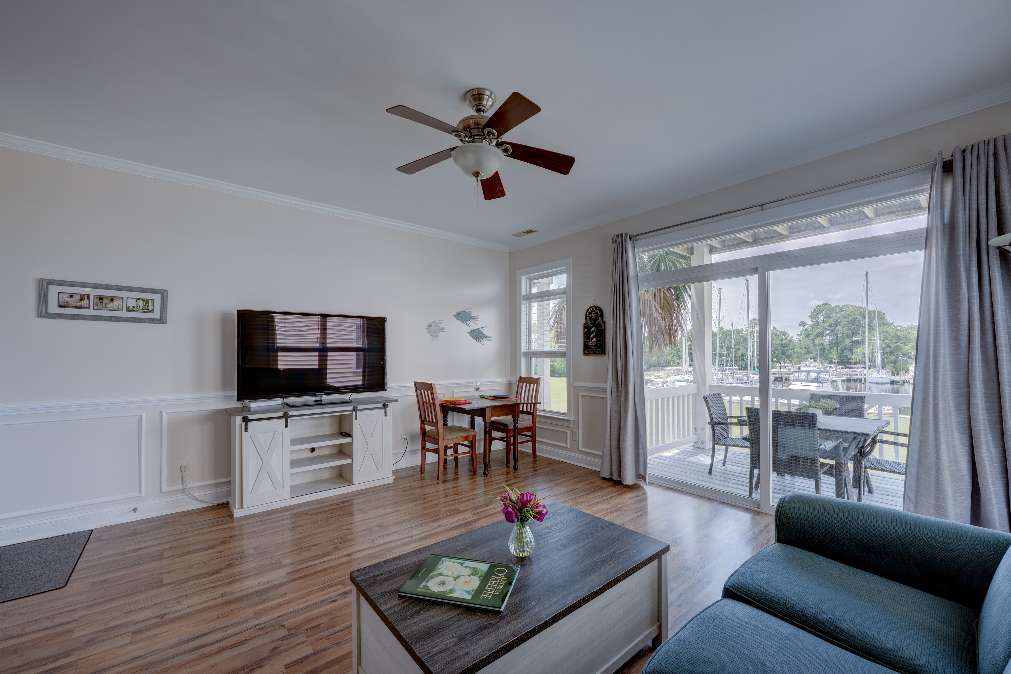 Living room with sliding glass doors opening to the deck and marina view