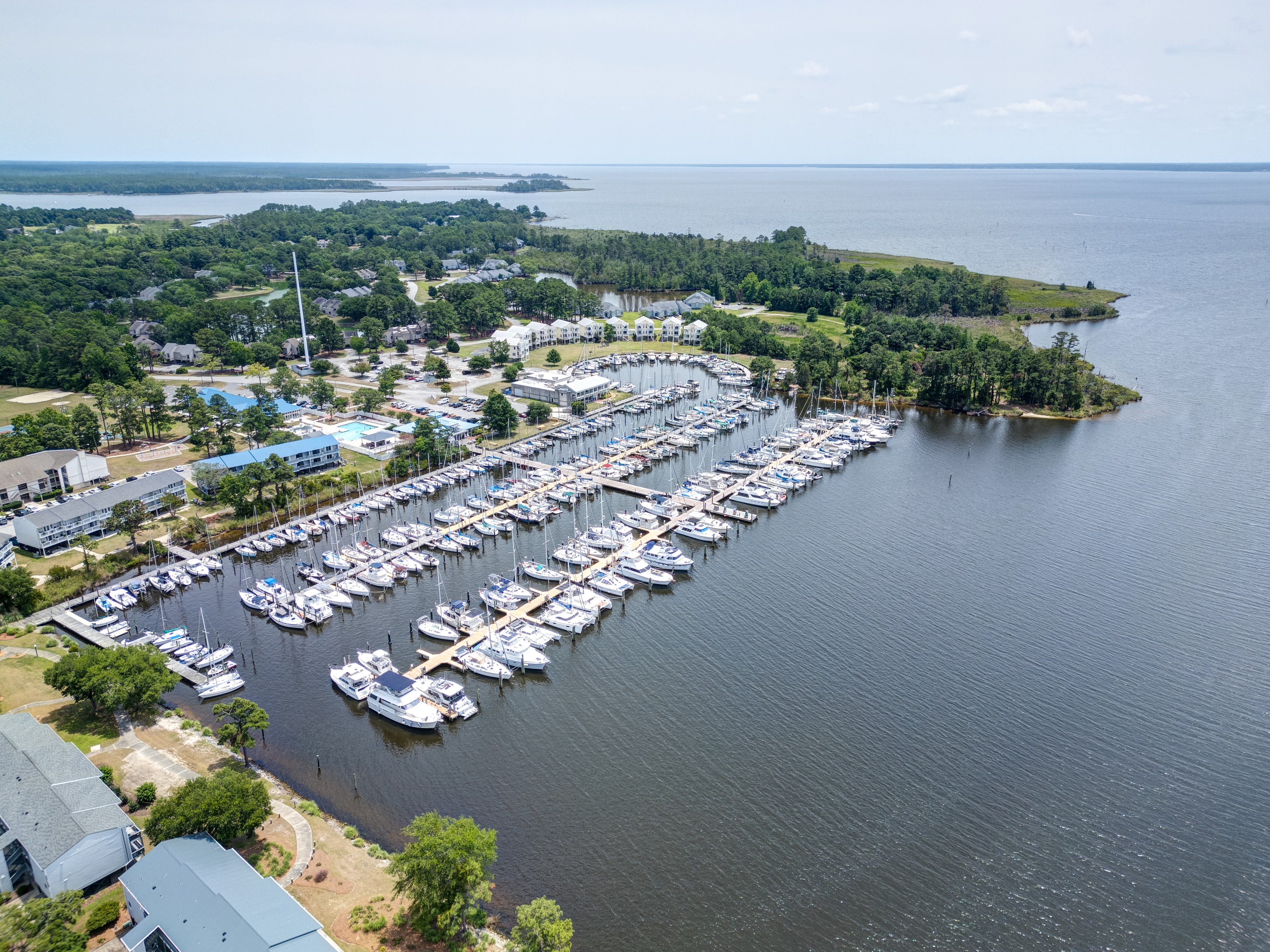 Aerial view looking out over the full marina and Neuse River
